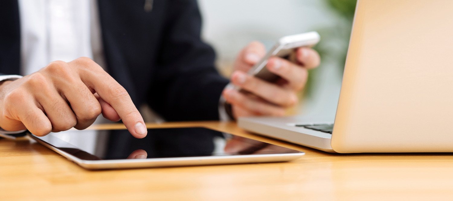 Property owner reviewing connectivity plans on a tablet and laptop