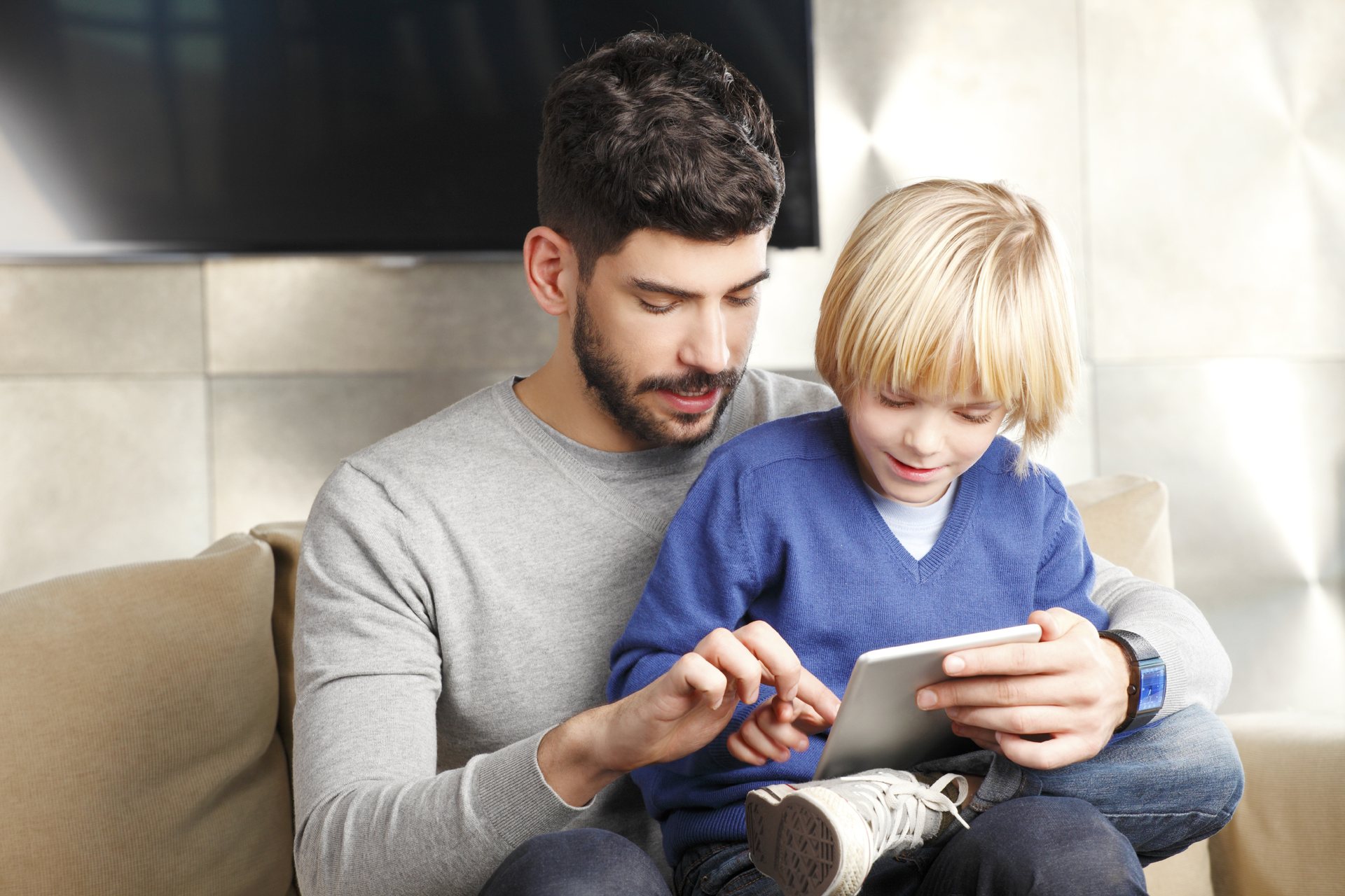 Father and son using a tablet together